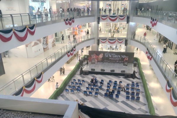 The Quantum Skyview atrium in Gateway Mall 2 from an upper floor: the LED ceiling overhead, a small stage below.